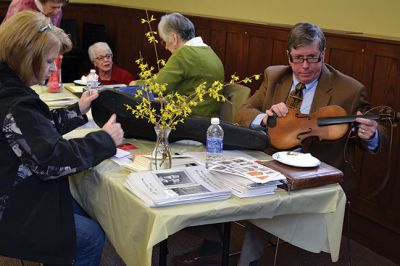 Library Treasures
Word spread of the Antiques Roadshow-style fundraiser at the Mattapoisett Library on March 29, attracting scores of South Coasters clutching their treasures, antiques, and heirlooms for appraisal and admiration, hoping Francis McNamee of the Marion Antique Shop might discover worth in their belongings beyond their sentimental value. Paying $5 per item appraised, some brought primitive dolls, old books, tea sets, and artwork. By Jean Perry
