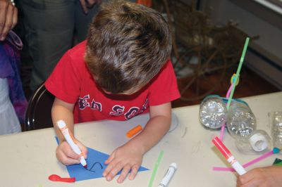 Boats from Recycled Materials
Youngsters gather last Thursday for the Mattapoisett Historical Society’s event making boats out of recycled materials. Rainy conditions only added to the fun, as the kids were able to test the seaworthiness of their crafts in a small pool outside of the museum. Photos by Shawn Badgley. 
