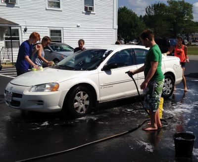 SCC Car Wash
The SouthCoast Children’s Chorus – along with parents and patrons – scrubbed for bucks during a car wash at the Mattapoisett Fire Station on Saturday afternoon, raising money for their general fund with a busy performance schedule coming up. “We hold fundraisers to support the work, the growth, and the performances of the Chorus,” Artistic Director Leslie Piper said. “We want every child to be able to sing, so we offer tuition scholarships for those who need them.” Photo by Shawn Badgley.
