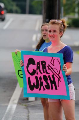 Car Wash!
The Lady Bulldogs took to the street on July 9, 2011, washing cars at the Mattapoisett Fire Department to raise funds for Old Rochester Regional Girls� Basketball team uniforms and supplies. Photo by Anne Kakley.
