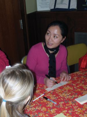 Chinese Culture
Children learned about Chinese culture and the Year of the Rabbit at a February 24, 2011 Mattapoisett library event. Librarian Linda Burke read a traditional Chinese story, and then the children enjoyed making their own dragons, watched as Haiying Zhang wrote their names in Mandarin, and tried eating fried rice with chopsticks. Photo by Anne Kakley.
