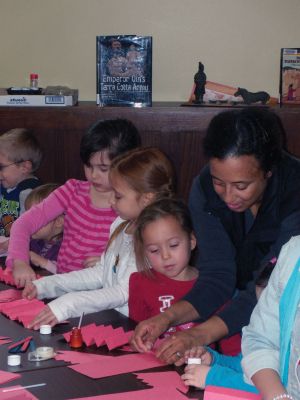 Chinese Culture
Children learned about Chinese culture and the Year of the Rabbit at a February 24, 2011 Mattapoisett library event. Librarian Linda Burke read a traditional Chinese story, and then the children enjoyed making their own dragons, watched as Haiying Zhang wrote their names in Mandarin, and tried eating fried rice with chopsticks. Photo by Anne Kakley.
