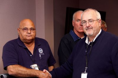 Helping Haiti
Joseph Corazzini, left, accepts a letter of appreciation from Federal Emergency Management Agency Administrator W. Craig Fugate, right, for his work in Haiti providing communication support to White House staff after a devastating January earthquake left the country in a state of emergency. Photo courtesy of Dennis Pinkham.
