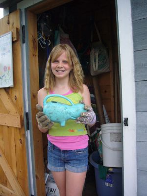 Gardens by the Sea
Bella Romig and her Hippo Watering Can. Romig helped give a tour of the Sippican School Community Garden on Friday during Gardens by the Sea. Photo by Joan Hartnett-Barry
