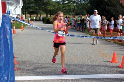 Rochester Road Race
Meg Hughes, one of the most promising athletes in the region, crosses the finish line in victory among a crowded Rochester Road Race field on August 10, 2013. Photo by Nick Walecka.
