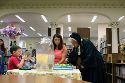 Elizabeth Taber Library
The Elizabeth Taber Library’s Open House featured a very important guest last week: Elizabeth Taber herself, as played by Natalie Hemingway. The festivities included a cake to celebrate what would be the Marion benefactor’s 222nd birthday, a presentation from Hemingway and Library Director Libby O’Neill, and more. Photo by Shawn Badgley. 
