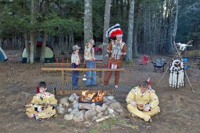 Scouts Cross Over
Haakon Perkins and Lee Estes of Mattapoisett took part in an impressive ceremony the last weekend in March at Camp Tinkham in Mattapoisett where they formally graduated from the Webelos pack to the Cub Scout troop during a crossing over ceremony that included fellow scouts and family members. The ceremony borrowed from Native American clothing and ceremonial techniques. (Photo courtesy of Bodil Perkins).
