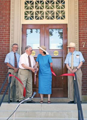 Ribbon Day
Mattapoisett Library Director Judith E. Wallace and Project Manager Francis H. Gordon (center) cut the ribbon during the formal dedication ceremony for the newly-expanded and renovated Mattapoisett Free Public Library on Tuesday afternoon, July 15, while Ms. Wallaces husband, David Gries (far left) and Project Manager Robert A. Cattley, PE (far right) look on. (Photo by Kenneth J. Souza).
