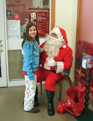 Letters to Santa
Fifth grade student Samantha Babineau of Rochesters Memorial School tells Santa what shed like for Christmas in person during his recent visit to the Rochester Post Office on Saturday, December 20. Santa also stopped by the Mattapoisett Post Office that same morning to check up on the tri-towns operations and to collect some last-minute wish lists and letters before heading back to the North Pole for his big night. (Photo by Robert Chiarito).

