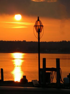 Winter Sunset in Mattapoisett
Although winter did finally rear its ugly head this week with a long overdue snowfall on Monday, this idyllic photograph taken recently at the Town Wharf in Mattapoisett is just another example of the fine weather weve been having this month. Apparently warm sunny days and scenic sunsets arent reserved for summertime anymore. (Photo by and courtesy of Carol Ingram).
