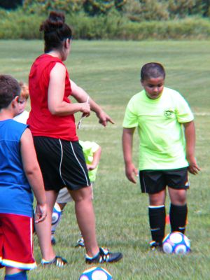 Getting A Kick Out of Soccer
An instructor shows a player how to properly handle the ball during a recent Soccer Academy training session held at the Mariner Soccer Club in Fairhaven. The next week-long training series starts on Monday, August 14 and there will be a walk-up registration day on August 18 for any player aged 7-14 who wishes to experience a day of the academy training. For more information, please call or e-mail Ray M. Cabral at 508-728-1377 or rcabral@umassd.edu. (Photo by Kenneth J. Souza).
