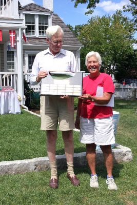 Winner on the Water
George Moffat, Jr., of Marion, poses with the trophy he won after handily winning the 2006 Annual Herreshoff Association Championship held in Marion aboard his Herreshoff, Swan Song. Posing with Mr. Moffat is Joey DuBois, who also presented him with the new Savvy Sailor Award, given in memory of her mother, Kathryn Watson Saltonstall, to the skipper over the age of 65 who placed highest in the fleet. (Photo by and courtesy of Anne T. Converse).
