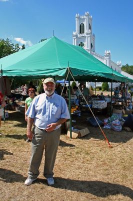 Bargain Hunting in Rochester
Reverend Leo Christian of the First Congregational Church of Rochester poses during the churchs 34th Annual Flea Market held on the town green on Saturday, September 1. There was a little something for everyone at the fundraiser as shoppers meandered from booth to booth carrying the days bargains and purchases. (Photo by Robert Chairito).

