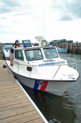 New Harbor Patrol Boat
The newly-purchased Mattapoisett Harbormasters boat underwent final preparations  including official lettering done by Assistant Harbormaster Ken Pacheco  earlier this week at the Town Wharf. The new vessel has been in service for about a week now and Harbormaster Steve Mach said the boat, with a higher enclosed cabin, will come in handy especially during the colder winter months. (Photo by Kenneth J. Souza).
