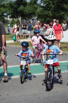 Easy Riders
Young riders prepare to participate in the second annual Tri-Town Ride for Kids which took place at Center School in Mattapoisett on Saturday, June 14 as part of the Pan Mass Challenge (PMC) to benefit the Jimmy Fund and the Dana-Farber Cancer Institute in their fight against cancer. Organized by local residents and spearheaded by Kathy Gauvin, the event saw hundreds of kids ranging in age from 3 to 15 years ride through the tree-lined streets of Mattapoisett Village. (Photo by Robert Chiarito).
