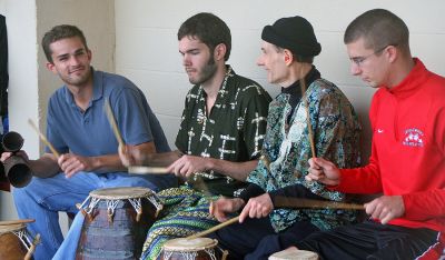 Beachside Tribute
UMass Dartmouth's Kikele Drumming Ensemble performs as friends and relatives of Curtis Doherty joined forces with the Marion DPW to spruce up the Silvershell Beach bath house in Marion over the past several weekends, painting it with environmentally-friendly, low VOC paint. Curtis spent countless hours over his lifetime on Silvershell Beachs basketball court and last year teammates and friends designed and constructed granite and wood benches for the basketball court in Curtis memory.
