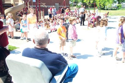 Mudgie's Namesake 2
Maurice Mudgie Tavares, a longtime staff custodian at Center School in Mattapoisett and a dedicated benefactor of the town's youth, looks on while students file out for the dedication of the school's playground in his honor. (Photo by Kenneth J. Souza).
