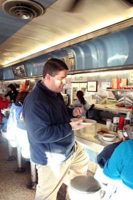 Fox at the Nest
Doug "VB" Goudie of Fox 25 Morning News samples an item from The Nest Diner's menu during the recent segment of "Diner Wednesday" broadcast from the Mattapoisett establishment on December 3, 2008. (Photo by Robert Chiarito).
