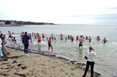Chilly Christmas Dip
Just some of the 60 estimated participants who braved the chilly weather to take the plunge into the water off the Mattapoisett Town Beach for a Christmas day swim to benefit the local Helping Hands and Hooves organization on the morning of December 25. One of the horses from the local Seahorse Farms where the non-profit organization is based even got into the act. (Photo courtesy of Debbi Dyson).
