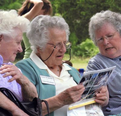 Family Affair
Louise Sylvia Hogan (92) looks over family photos during the recent family reunion of the John S. and Emilia F. Sylvia family held at the Holy Ghost Grounds in Mattapoisett on July 15. The event drew four generations of Sylvia descendants, all of whom can claim roots to Mattapoisett and the tri-town area. (Photo courtesy of Natalie Sylvia Hemingway).
