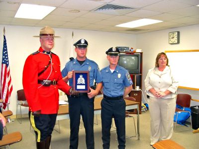 Police Commendation
Constable Greg Lupson of the Major Crime Unit of the Royal Canadian Mounted Police recently presented Mattapoisett Patrolman Andrew Murray, Sergeant Jason King, and Police Chief Mary Lyons with an award from Canadian authorities for their great teamwork and quick thinking in apprehending Gregory Despres on the night of April 26, 2005. (Photo by Nancy MacKenzie).
