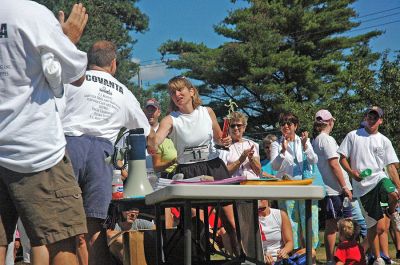 Women's Winner
Karen Regan of Somerset, MA, receives her award from Scott Muller, President of Rochester Road Race, for being the womens overall winner with a finish time of 22:06. (Photo by Angela Kantner).
