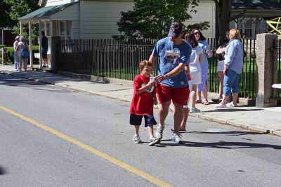 Marion Village 5K
A weary young participant in the 2007 tenth annual running of the Marion Village 5K Road Race gets some much-needed refreshment from his dad. (Photo by Robert Chiarito).
