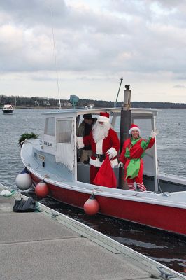 Here Comes Santa Claus
Jolly Saint Nick arrives via "water sleigh" in Sippican Harbor to pay an early Christmas visit to Marion residents during the annual Village Stroll held on Sunday, December 14. (Photo by Robert Chiarito).
