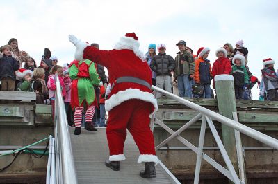 Here Comes Santa Claus
Jolly Saint Nick arrives via "water sleigh" in Sippican Harbor to pay an early Christmas visit to Marion residents during the annual Village Stroll held on Sunday, December 14. (Photo by Robert Chiarito).
