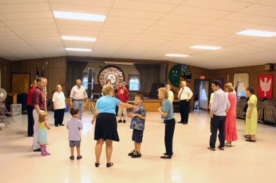 Do-Si-Do in Marion
On Sunday, September 14, the first of what is hoped to be an annual series of Marion Square Dances was held inside the Marion Community Center. Although initially slated to take place in the parking lot adjacent to the Marion General Store, the weekends rainy weather forced the event indoors. Caller Jim Schell of Lakeville had veteran square dancers and novices alike promenading, allemanding, bowing to their partners and do-si-doing with ease. (Photo by Robert Chiarito).
