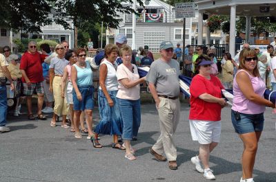 Glory Unfurled
Mattapoisett's weeklong 150th Sesquicentennial Celebration was capped off with a closing ceremony featuring the glorious unfurling of three large versions of the Stars and Stripes, courtesy of the National Flag Truck exhibit, in the area of the Town Wharf and Shipyard Park on Sunday afternoon, August 12. (Photo by Tim Smith).
