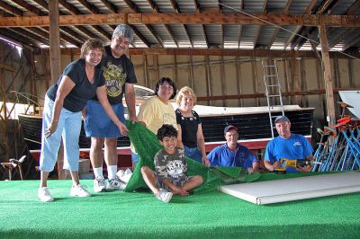 Parade Prep
Members of the Mattapoisett Water Department worked to assemble the Mattapoisett Town Float this past week in preparation for the 150th Sesquicentennial Parade to take place on Saturday, August 4, kicking off a week filled with events. Here workers pose with Mattapoisett Selectman Steve Lombard and his wife Joyce (far left), Town Clerk Barbara Sullivan (third from left), and Assistant to the Town Administrator Melody Pacheco (fourth from left) on the float-in-progress. (Photo by Kenneth J. Souza).
