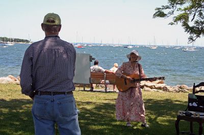 Painting in the Park
Marion artist Charles Parsons (foreground) paints a portrait and landscape as Mattapoisett Library Director and musician Judy Wallace performs (background) during the recent "Arts in the Park" benefit held in Mattapoisett's Shipyard Park on Sunday, June 24. (Photo by Robert Chiarito).
