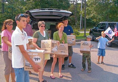 Cape Care Packages
Members of the Lynch Family, whose son PFC Daniel Lynch is serving in Afghanistan, help ship out the 2000th care package as part of the Cape Cod Cares for the Troops effort which Mattapoisett Boy Scout Troop 53 has taken on as an ongoing project. The troop still maintains a collection location at Mailbox Services on Route 6 in Mattapoisett and encourages donations. (Photo courtesy of Ron Ellis).
