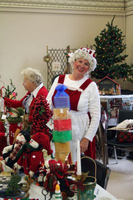 Santa's Helper
Joanne Riley is ready for Christmas in her Mrs. Claus outfit as she assists early shoppers like Jackie Goddeniff, left, during the Mattapoisett Congregational Churchs recent Christmas Fair held on Saturday, November 15 in the churchs Reynard Hall. The event brought out more than the usual number of people, all looking for good deals and great early bargains during this financially-tight holiday season. (Photo by Robert Chiarito).

