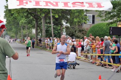 Mattapoisett Road Race 2008
Jeff Reed of Fall River crosses the finish line in 28:22 to place third overall in the Mattapoisett Road Race held on July 4, 2008. (Photo by Kenneth J. Souza).
