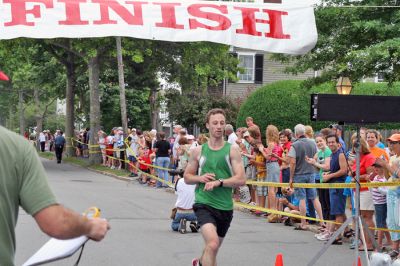 Mattapoisett Road Race 2008
Matthew Graziano of Norfolk, MA crosses the finish line in 28:25 to place fourth overall in the Mattapoisett Road Race held on July 4, 2008. (Photo by Kenneth J. Souza).
