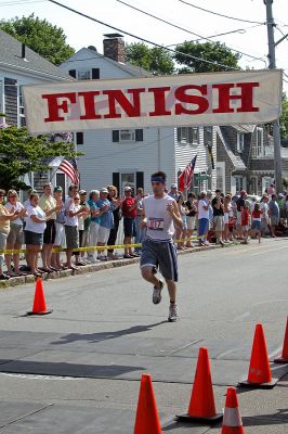 2007 Mattapoisett July 4 Road Race
Bryan Galvin of Seekonk crosses the finish line in the 37th annual Mattapoisett July 4 Road Race, finishing fourth overall in 28:38 with a pace of 5:44. (Photo by Kenneth J. Souza).
