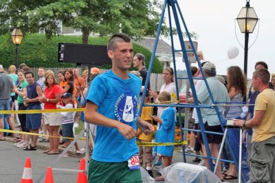 Mattapoisett Road Race 2008
Tyler Rose of Fairhaven crosses the finish line in 29:20 to place sixth overall in the Mattapoisett Road Race held on July 4, 2008. (Photo by Kenneth J. Souza).
