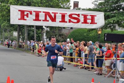 Mattapoisett Road Race 2008
Andrew McIntire of Mattapoisett crosses the finish line in 30:11 to place eighth overall in the Mattapoisett Road Race held on July 4, 2008. (Photo by Kenneth J. Souza).
