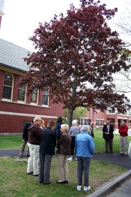 Permanent Planting
Family and friends gather for the unveiling of a newly-installed plaque rededicating the red maple tree just beneath the clock tower at Center School in memory of Suzanne Rogers, a first grader at the school who died tragically in 1977 when she was struck by a car. The Mattapoisett School Committee commissioned a new plaque to forever announce the trees significance. (Photo by Robert Chiarito).
