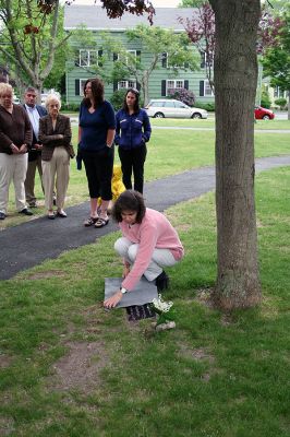 Permanent Planting
Mattapoisett School Committee Chairman Elizabeth Milde unveils the newly-installed plaque rededicating the red maple tree just beneath the clock tower at Center School in memory of Suzanne Rogers, a first grader at the school who died tragically in 1977 when she was struck by a car. The Mattapoisett School Committee commissioned a new plaque to forever announce the trees significance. (Photo by Robert Chiarito).
