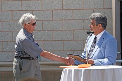 Water Works
Lifelong Mattapoisett resident Howard Tinkham accepts a citation from Mattapoisett Selectman Steve Lombard during the dedication of the Mattapoisett River Valley Water District's Treatment Plant on Friday, May 30. Mr. Tinkham generously offered part of his family's land for the facility. (Photo by Kenneth J. Souza).
