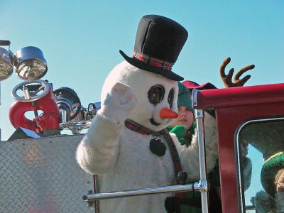 Here Comes Santa Claus
Santa arrives in Shipyard Park during Mattapoisett's first annual Holiday Village Stroll on Saturday, December 2. Santa also brought along Mrs. Claus, his helpful elves, Rudolph the Red-Nosed Reindeer, and Frosty the Snowman to delight children during the festivities. (Photo by Robert Chiarito).
