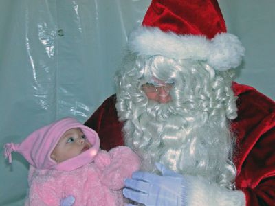 Santa, Baby
Simonne Chiarito has her first sitdown with Santa Claus during Mattapoisett's first annual Holiday Village Stroll on Saturday, December 2 at Shipyard Park. (Photo by Robert Chiarito).
