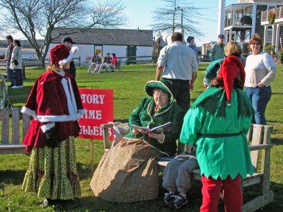 Seasonal Storytelling
Storytellers offers holiday tales during Mattapoisett's first annual Holiday Village Stroll on Saturday, December 2 in Shipyard Park. The event included a visit from Santa Claus, Mrs. Claus, and friends, along with the traditional town tree lighting ceremony. (Photo by Robert Chiarito).
