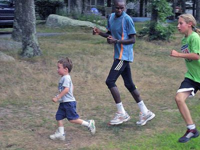 Running Man
Kenyan runner Nicholas Kamakya trained with the kids in the final Marion Mile Just for Kids competition held last week at Tabor Academy. The athlete talked about running in Kenya and led the kids through warm-ups and stretching prior to jogging along in the back of the pack with some of the youngest competitors. (Photo courtesy of Chris Adams).
