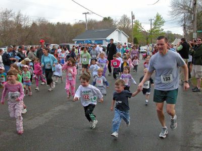 Mom's Marathon '07
An estimated 400 runners and walkers came out to the Oxford Creamery in Mattapoisett on Sunday, May 13 to participate in the first annual Tiara Classic Mothers Day 5K Road Race. The race was held to benefit the Womens Fund of Southeastern Massachusetts. Many of the runners donned tiaras and capes, making this event one of the more colorful local road races. (Photo by Robert Chiarito).
