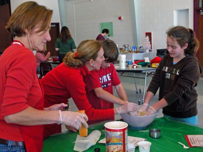 Cookies and Caring
Sixth grade students at Old Hammondtown School in Mattapoisett recently prepared baskets of homemade cookies and other goodies as part of their eighth annual holiday program. With help from parents, teachers and staff, the students baked some 1,440 cookies to be packaged in about 130 handmade baskets for distribution to Mattapoisett seniors and shut-ins. (Photo by Robert Chiarito).
