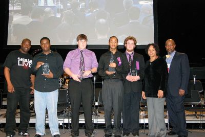 ORR Music Winners
(l. to r.) Drummer and Berklee alumnus John Blackwell, Marcellus Farmer, Aaron Janik, Tyrone Martin, Mack Williamson, Percussion Professor Terri Lynne Carrington and Music Education Chair Cecil Adderley pose at Berklee's Annual High School Jazz Festival.
